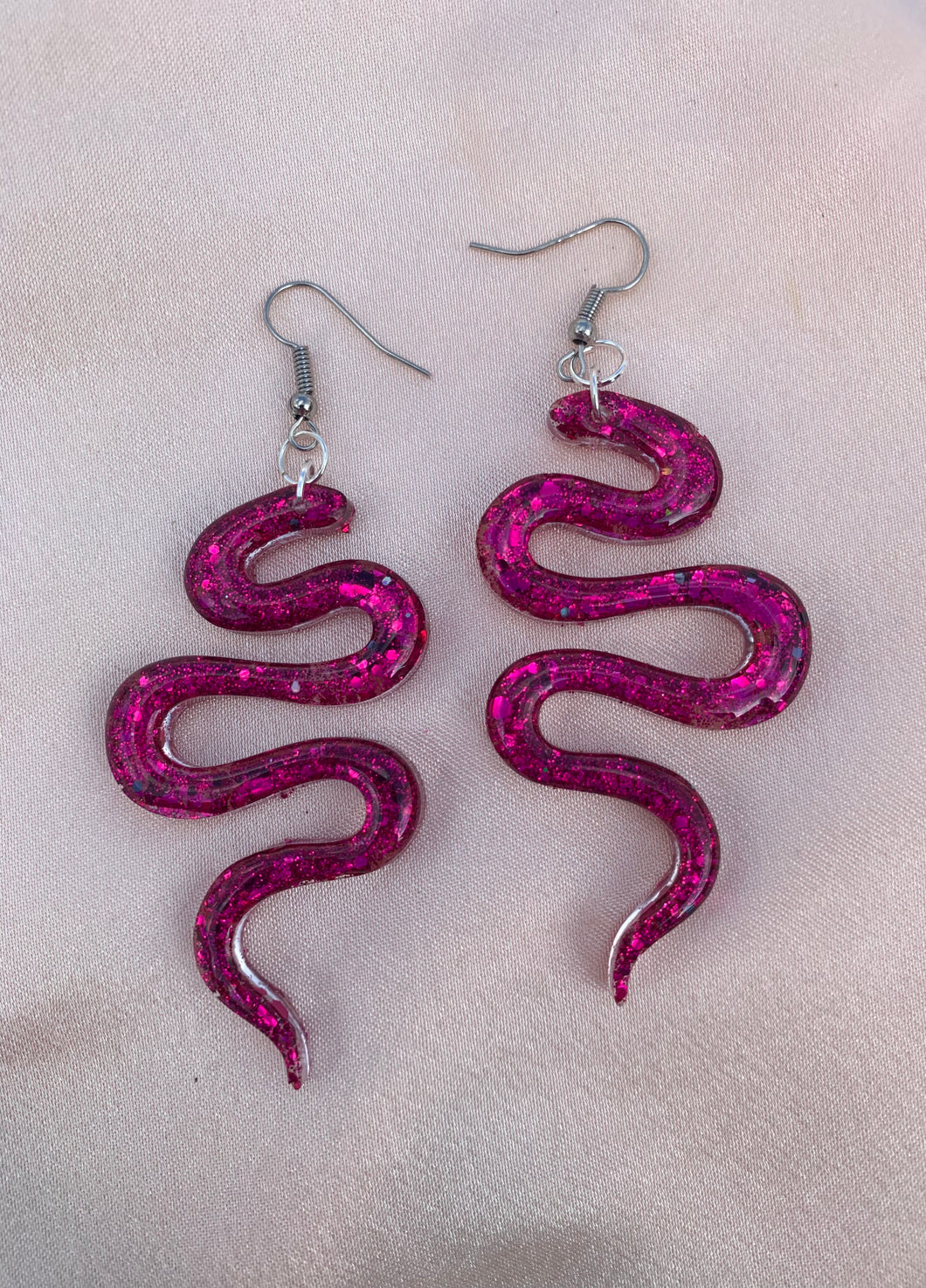 Dark pink glitter snake earrings