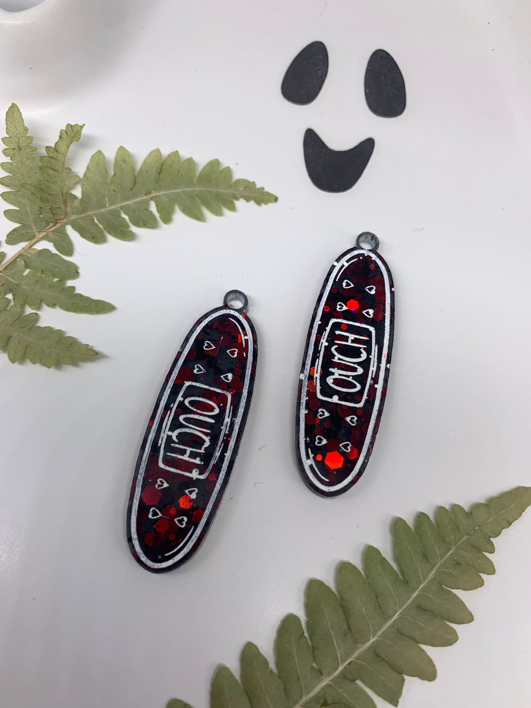 Red and black bandaid earrings