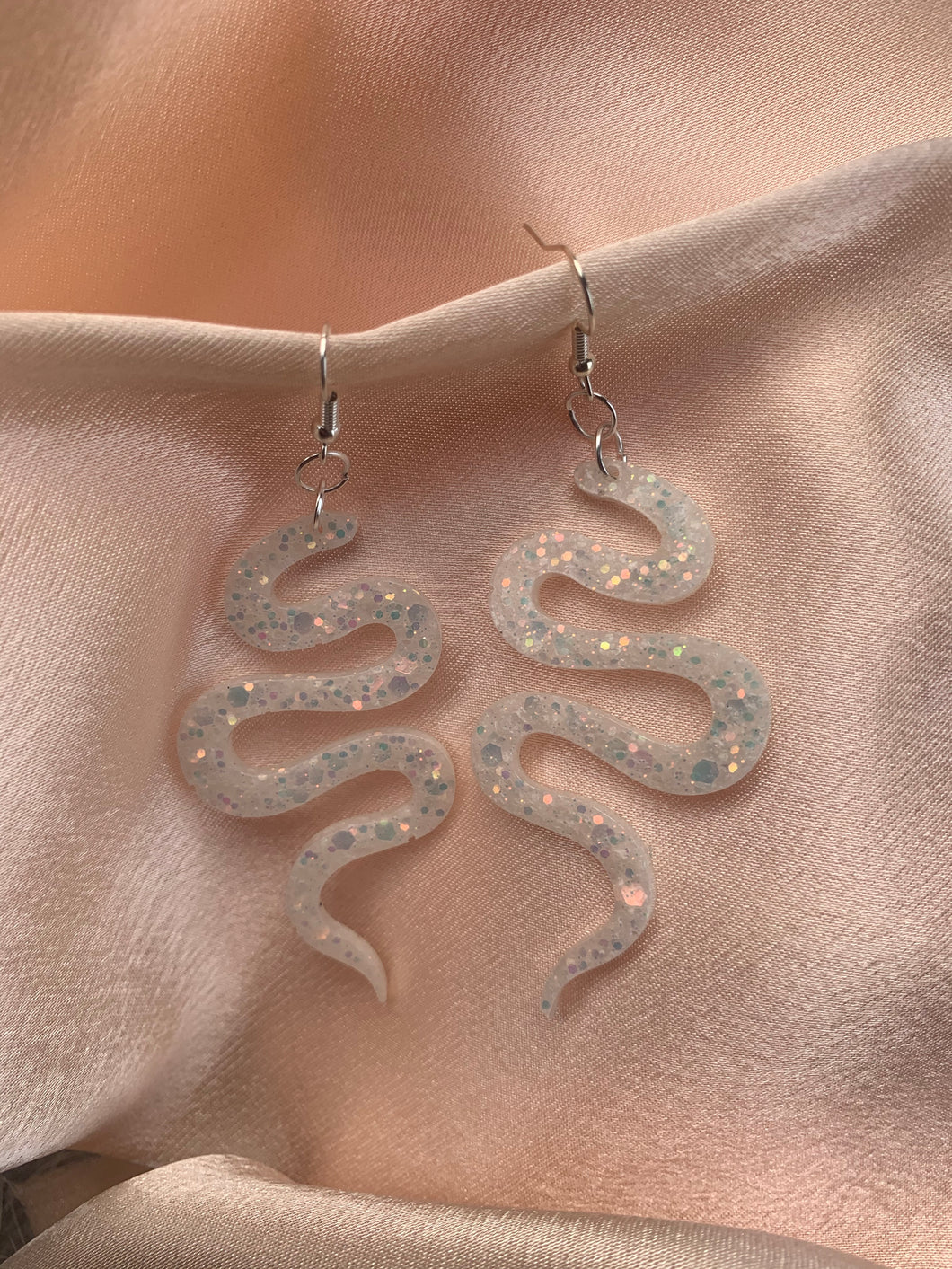 White iridescent snake earrings